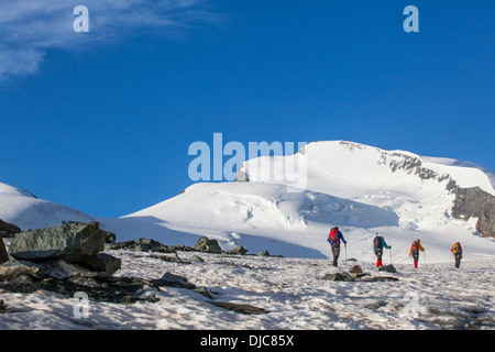 Mountaineers walking on a glacier in Switzerland Stock Photo