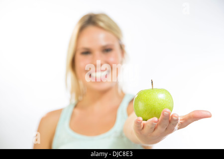 Young woman holding an apple Stock Photo