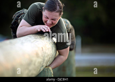 US Marine Pfc. Julia Carroll navigates her way through the obstacle course November 14, 2013 at Camp Geiger, N.C. Montenegro is one of three female Marines to be the first women to graduate infantry training on November 21, 2013. Stock Photo
