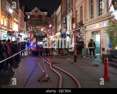 The Fire Service attend a smoke filled HSBC Bank Gerrard Street London UK 26th November 2013. The road was taped off at around 7.15pm as crowds watched the fire crews investigate and deal with the cause of the smoke. Credit Julian Eales/Alamy Live News Stock Photo