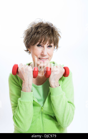 Mature woman exercising with hand weights Stock Photo