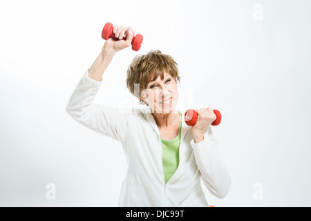 Mature woman excercising with hand weights Stock Photo
