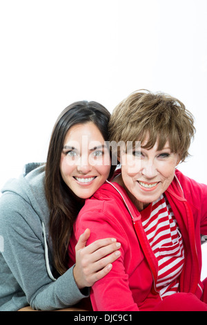Mature woman and younger woman in fitness gear on white background Stock Photo