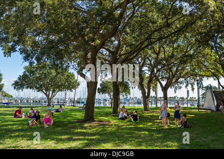 People picnicking on the grass at Progress Energy Park in downtown St Petersburg, Florida, USA Stock Photo