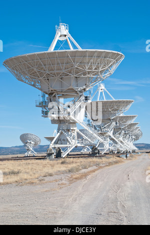 The massive radio telescopes at the Very Large Array  stand in stark contrast to the blue New Mexico sky. Stock Photo