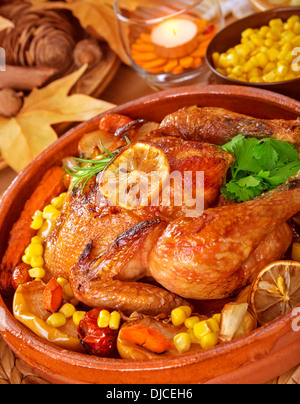 Tasty fried chicken served with fresh vegetables, good roasted chick with crunchy crust, homemade baked poultry, delicious food Stock Photo