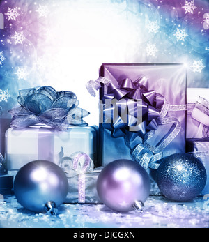 Photo of silver Christmas presents on falling snowflake background, different gift box wrapping in shiny paper Stock Photo
