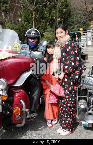 Young japanese garl with Harley Davidson on display, Japan Stock Photo