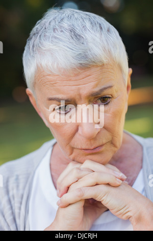 Pensive short haired elderly woman posing Stock Photo