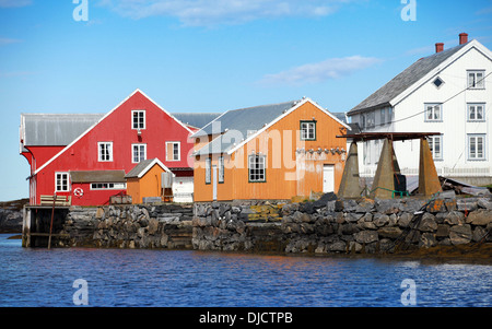 Traditional Norwegian village with colorful wooden houses on rocky coast Stock Photo