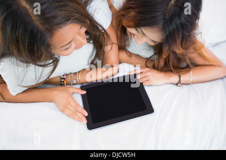 Two cute sisters using a tablet Stock Photo