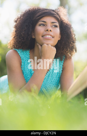 Gorgeous happy brunette reading book Stock Photo