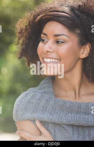 Gorgeous smiling brunette standing in sunshine Stock Photo
