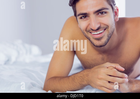 Handsome man lying on his bed Stock Photo