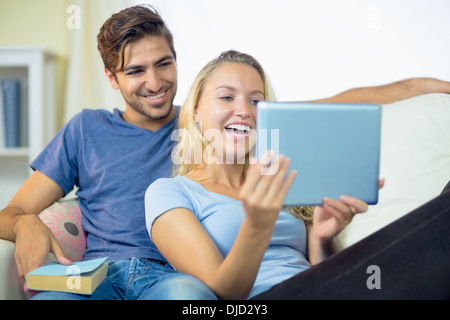 Happy laughing young couple using a tablet Stock Photo