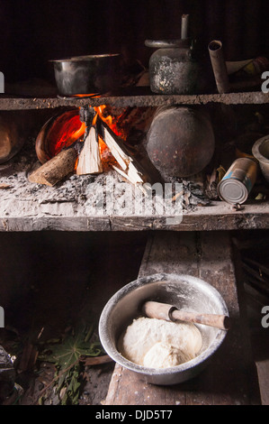 Food being prepared and cooked on an open wood fire in a cooking bure (hut) in the village on Namuka-I-Lau, Lau Islands, Fiji. Stock Photo