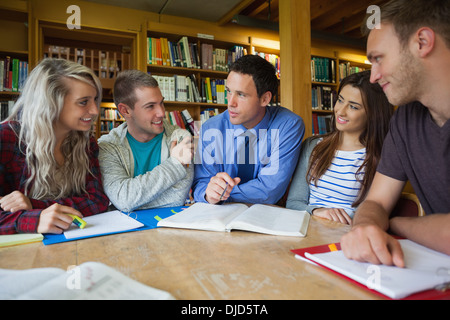 Lecturer explaining something to group of students Stock Photo