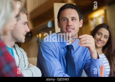 Happy lecturer explaining something to group of students Stock Photo