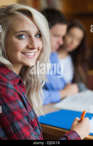 Blonde cheerful student studying with other students Stock Photo