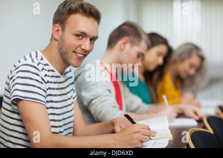 Smiling handsome student looking at camera Stock Photo