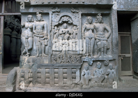 Mithuna couples on right of entrance of Chaitya hall. Intrusive Buddha image in between. Karla Caves, Pune, Maharashtra India. Stock Photo