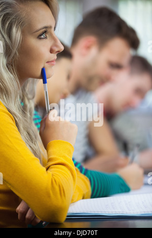 Thoughtful blonde student looking away Stock Photo