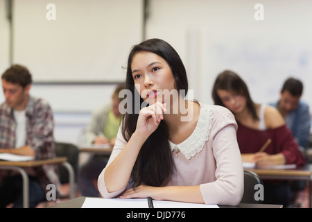 Focused asian student listening in class Stock Photo