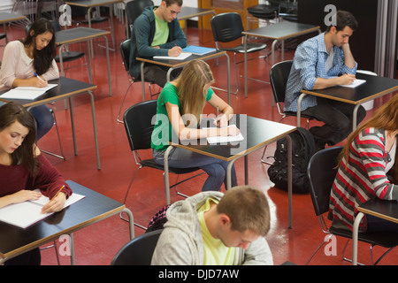 Students taking an exam in classroom Stock Photo