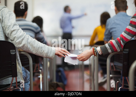 Students passing notes in class Stock Photo