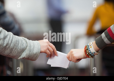 Students passing notes in classroom Stock Photo