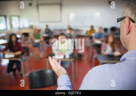 Lecturer speaking to his class of students Stock Photo