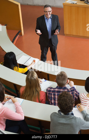 Happy lecturer speaking to his students Stock Photo