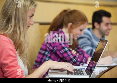 Happy students sitting in a lecture Stock Photo
