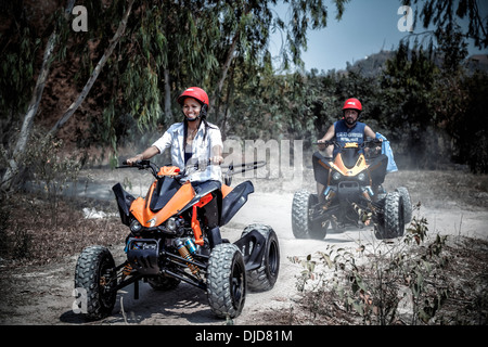 Woman riding an All Terrain Vehicle (ATV Stock Photo - Alamy