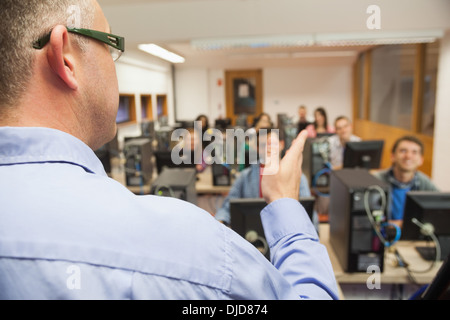 Smiling students listening to teacher in their computer class Stock Photo