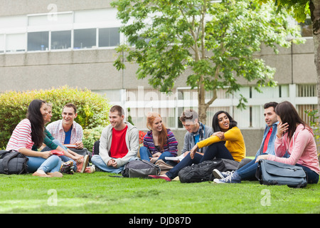 Group of students chatting on the grass on campus Stock Photo