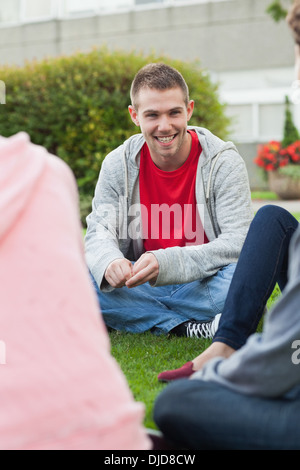 Cheerful students taking a break outside on campus Stock Photo