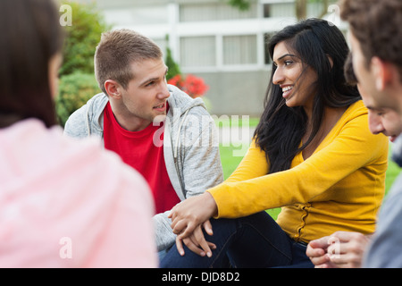 Cheerful young students taking a break outside on campus Stock Photo