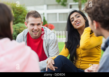 Happy young students taking a break outside on campus Stock Photo