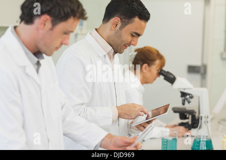 Handsome young scientist using his tablet Stock Photo