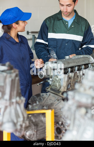 Trainee asking instructor about engine Stock Photo
