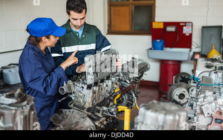 Instructor explaining engine to trainee Stock Photo