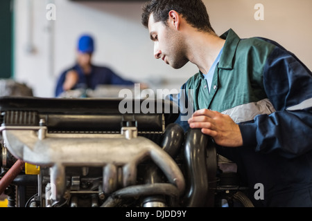 Instructor checking a machine Stock Photo