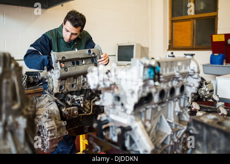 Repairman repairing an engine Stock Photo