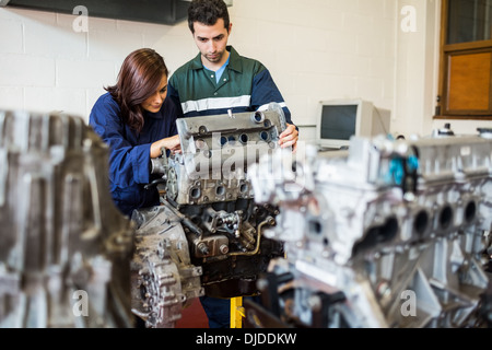 Trainee and instructor repairing an engine Stock Photo