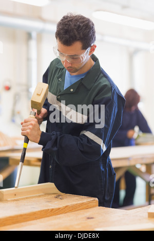 Carpenter using mallet and chisel Stock Photo