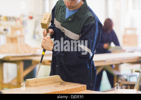 Craftsman using mallet and chisel Stock Photo