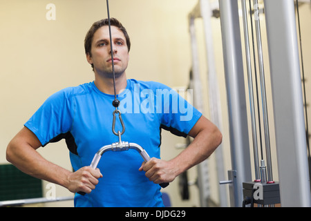 Man doing exercises in the gym on lat machine Stock Photo