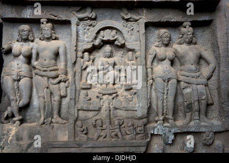 Mithuna couples on right of entrance of Chaitya hall. Intrusive Buddha image in between. Karla Caves, Pune, Maharashtra India. Stock Photo