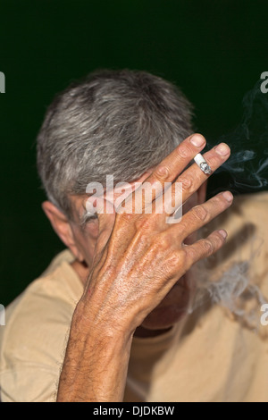 Elderly man smoking a cigarette Stock Photo